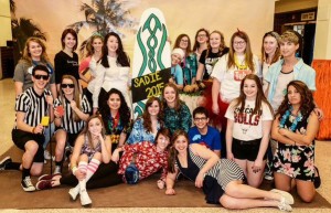 The 2014-15 Ell Ess Pe yearbook staff gathers for a group photo at LaSalle-Peru's Sadie Hawkins dance in March. Yearbook adviser Georgia Stohr is in the middle of the group behind the "Sadie 2015" sign. The yearbook staff is in charge of putting on the Sadie Hawkins dance each year.