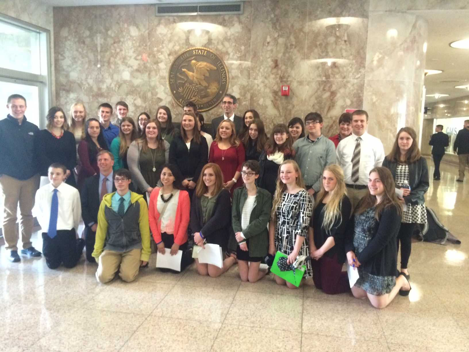 Journalism students from throughout Illinois stand with Rep. Will Guzzardi (D-Chicago) in Springfield on April 6. The bill to protect student journalists' free speech rights was unanimously voted through committee that day.